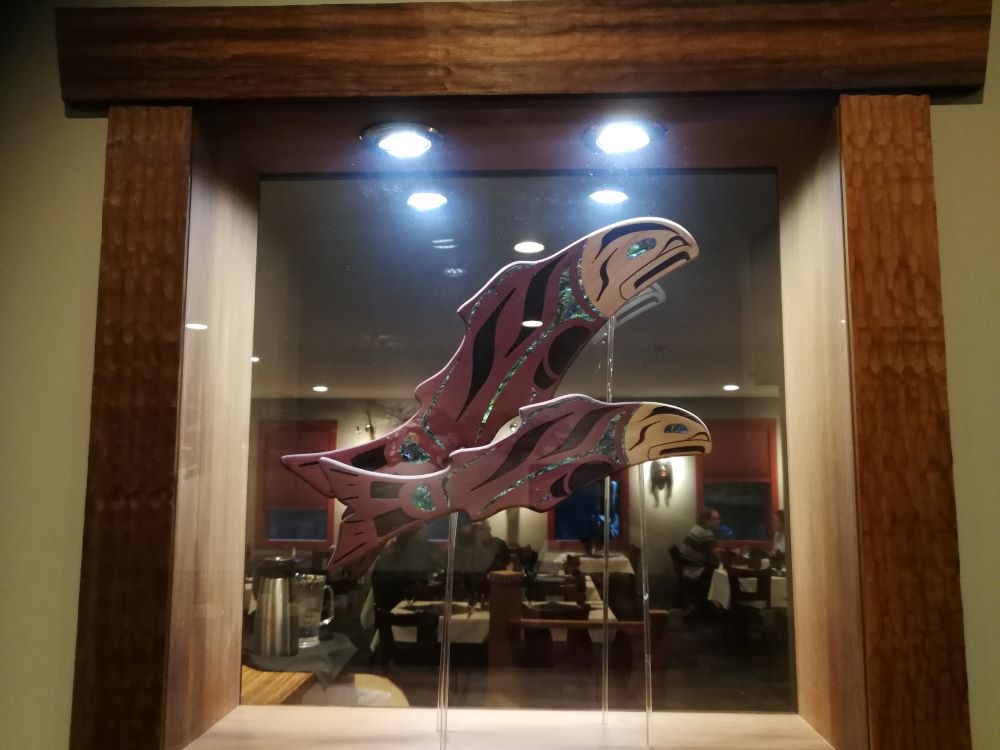 salmon artwork on the glass between the lobby and the restaurant