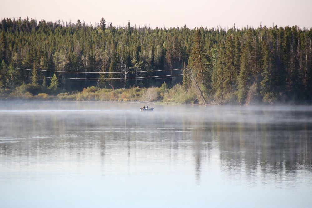 Two persons fishing from a boat on Nimpo Lake