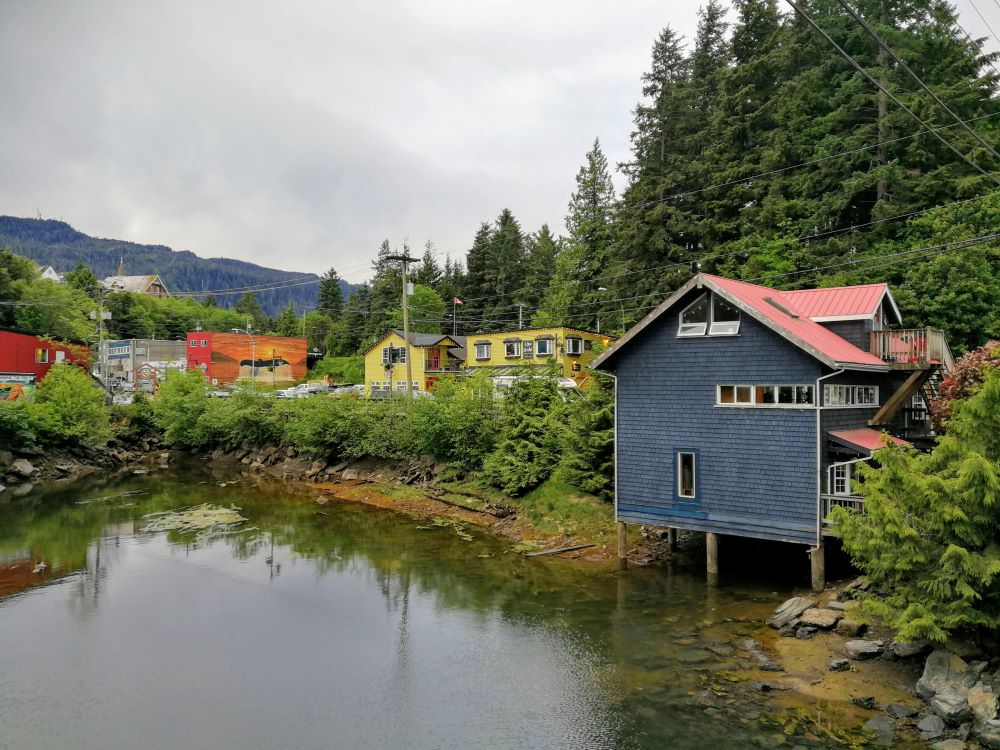 the back of a blue heritage building over the water at Cow Bay Prince Rupert